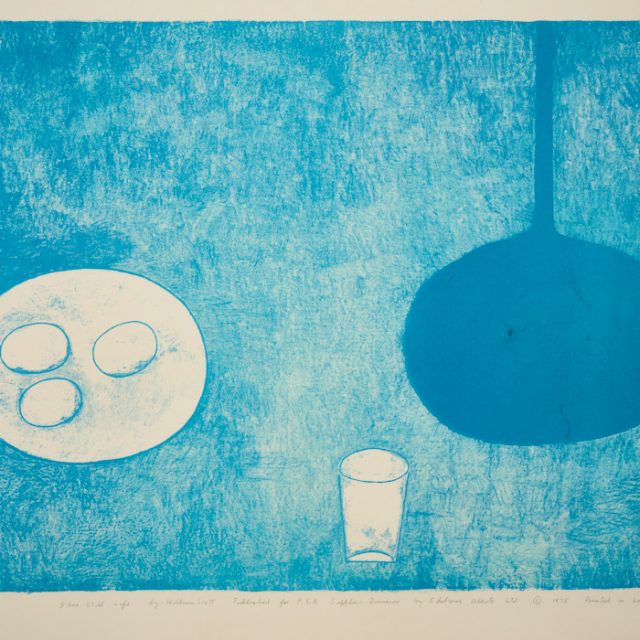 A blue etching depicts a round white plate on the left, with three white circular objects on it, at the centre bottom of the images is a tall white glass, and on the right, a deep blue vase with a tall neck and large round base.