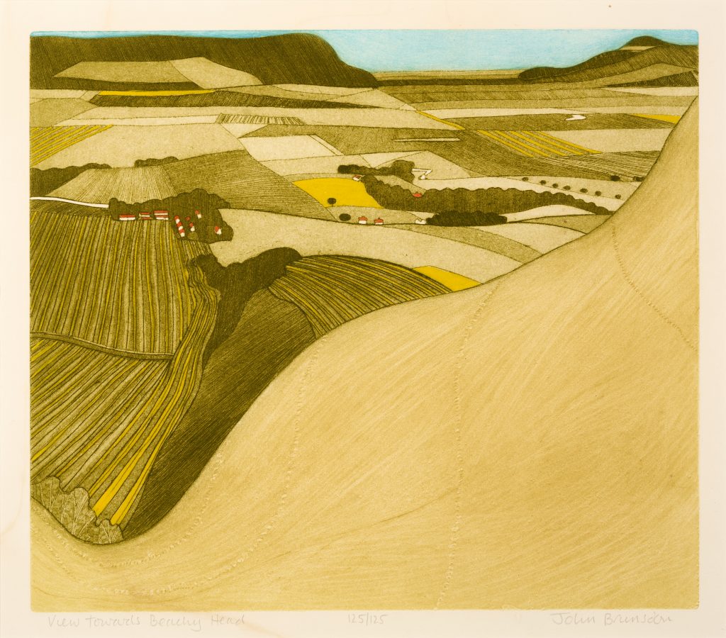 Colour print showing a view over ploughed fields, with coastline and blue sky in the distance