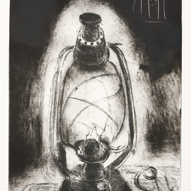 A black and white image showing a lit oil lamp on a table.