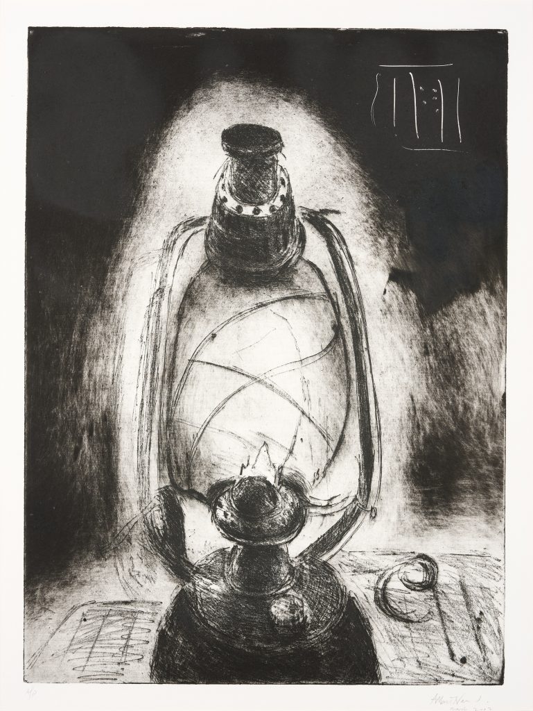 A black and white image showing a lit oil lamp on a table.