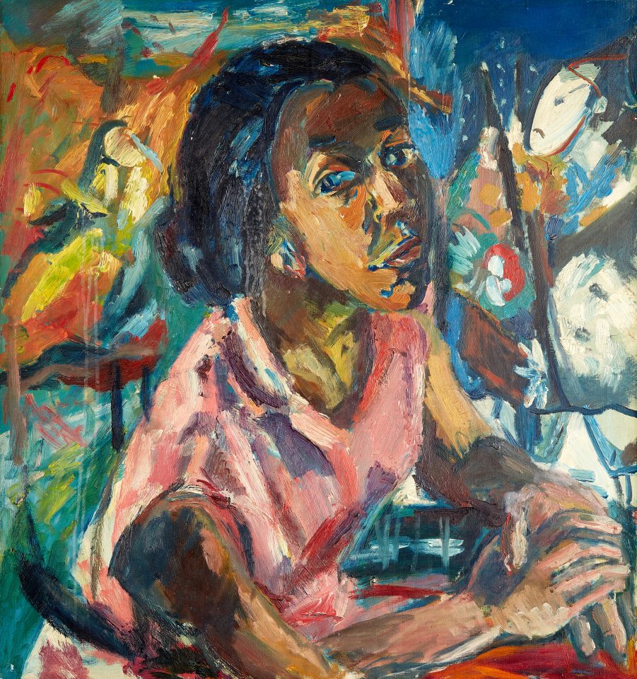 A colourful oil painting depicting a girl with dark skin sat profile to the viewer but turning and leaning forwards to look directly towards the viewer. Her hands rest over each other in front of her on a red surface, her clothing is pink with a collar, and her arms are exposed. Behind the figure is a colourful, abstract background.