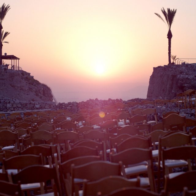 a film still showing a sunset over an outdoor theatre