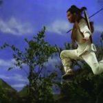 The picture shows a man jumping in nature.