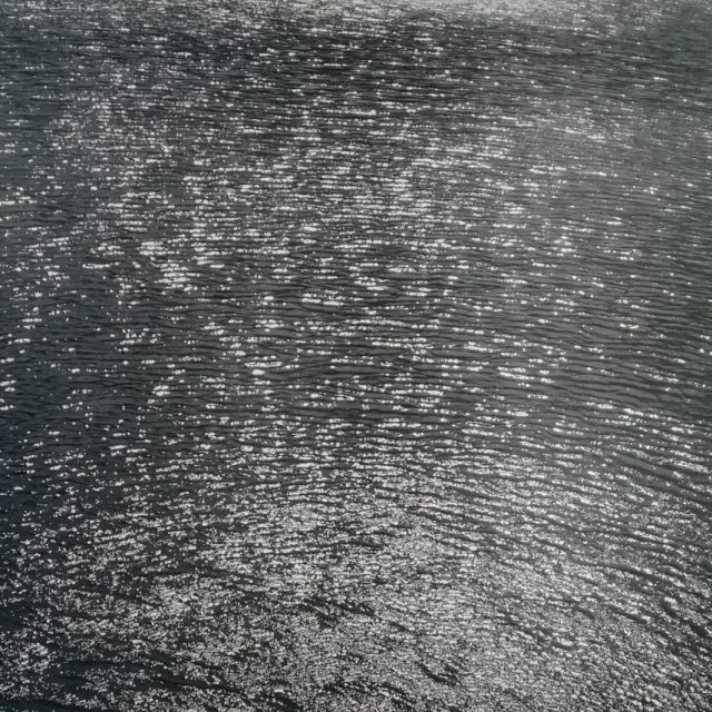 This is a black and white photo depicting a lake.