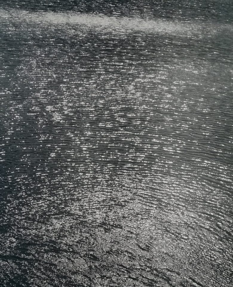 This is a black and white photo depicting a lake.