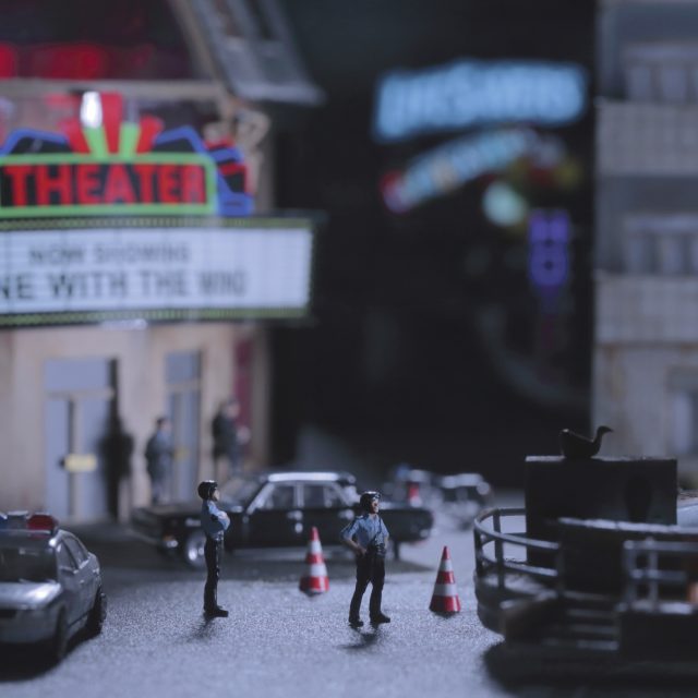 This image depicts several police officers standing in a small town.