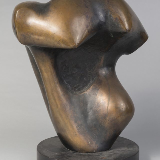 An abstract bronze sculpture on a plain gray background.