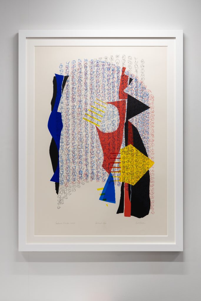 A colourful screenprint with a red, yellow, blue and black patern in a white frame.
